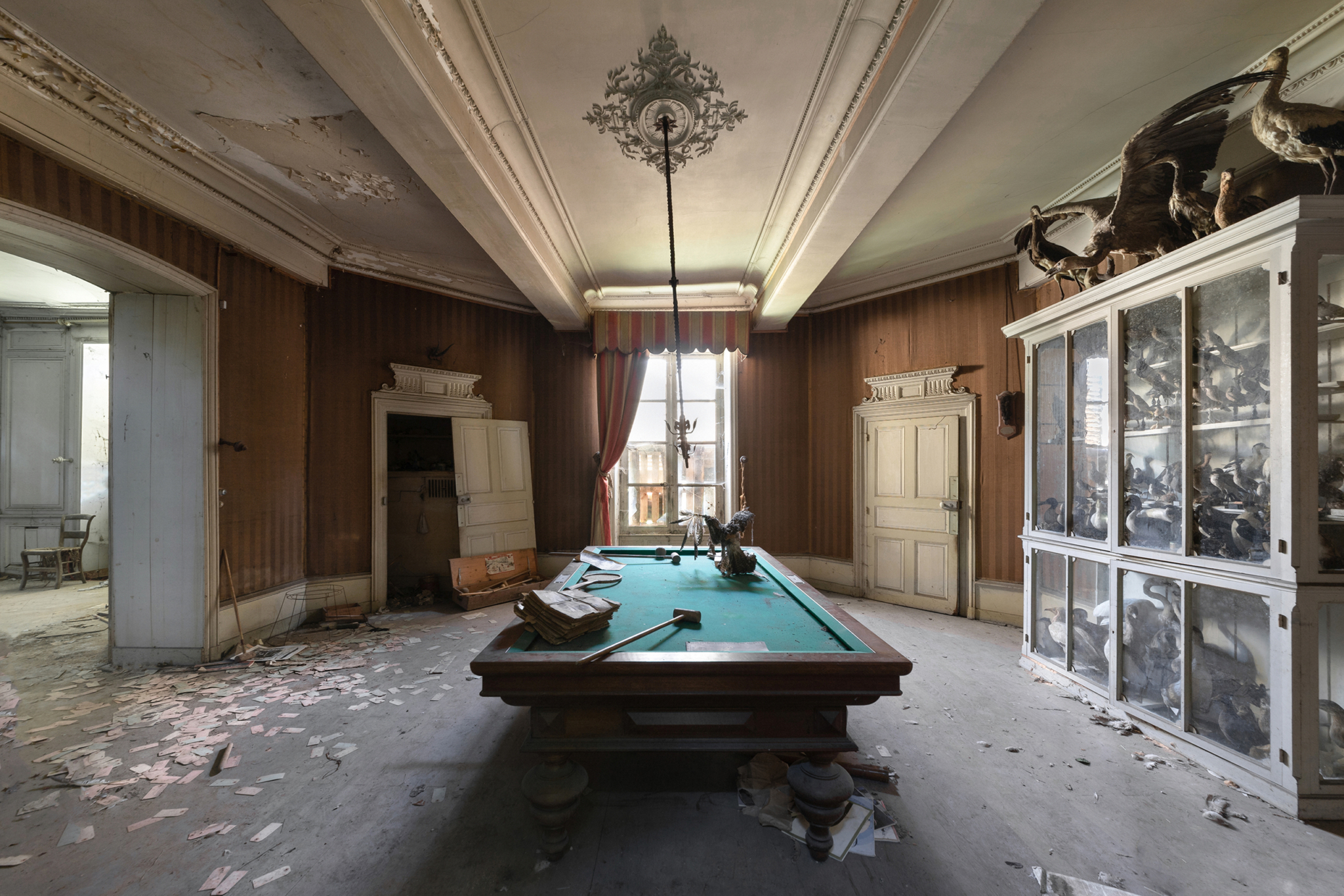 Abandoned room with a french pool inside a derelict castle