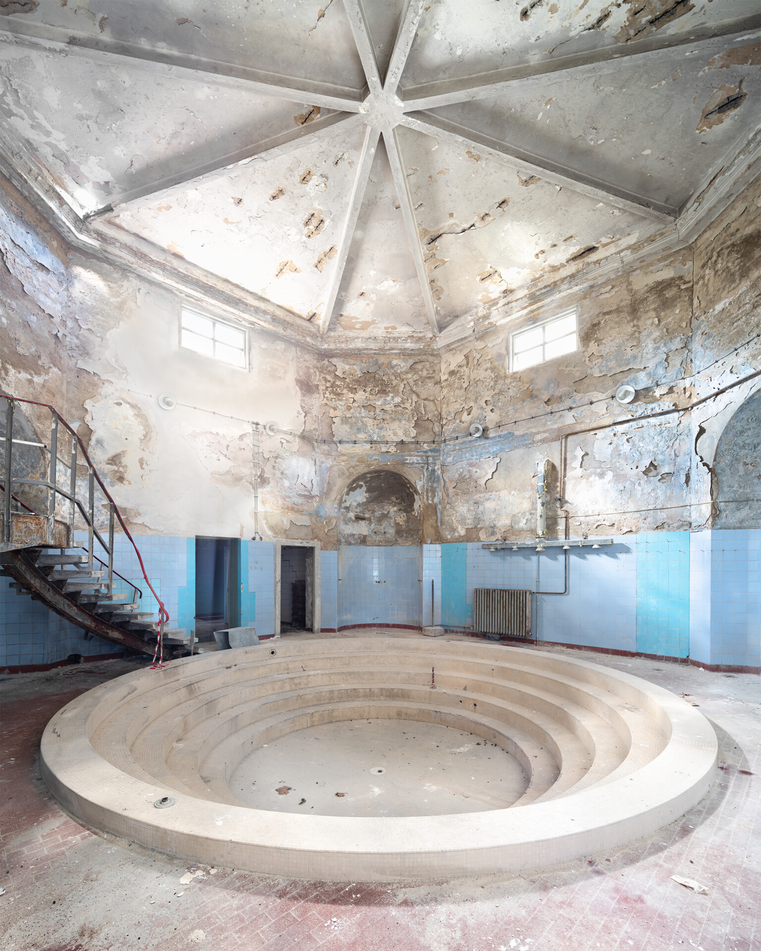 Blue pool with huge decay inside derelict baths in Europe